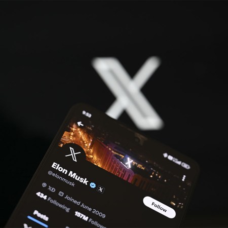 In this photo illustration, 'X' (formerly known as Twitter) Premium account of Elon Musk is displayed on a mobile phone screen in front of a computer screen displaying 'X' logo, in Ankara, Turkiye on September 19, 2023
