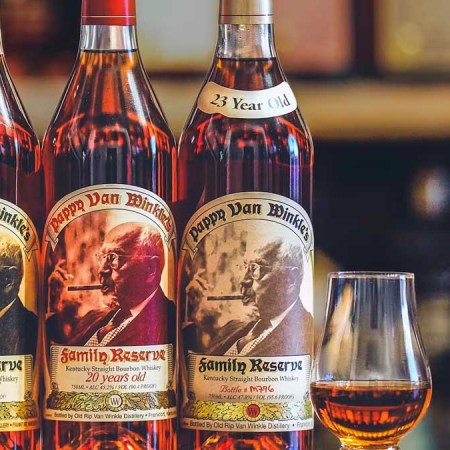 Three bottles of Pappy Van Winkle and a Glencairn glass. Huckberry is giving away three Pappy bottles.