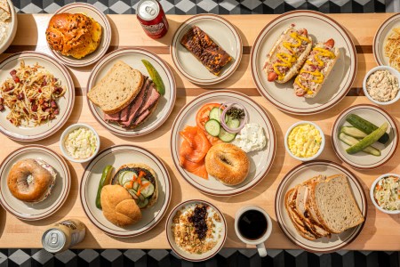 Spread of sandwiches and other toppings and drinks across a table