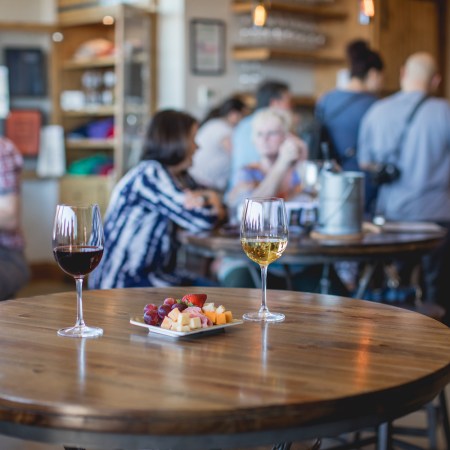 Wine glasses on a table with a cheese plate