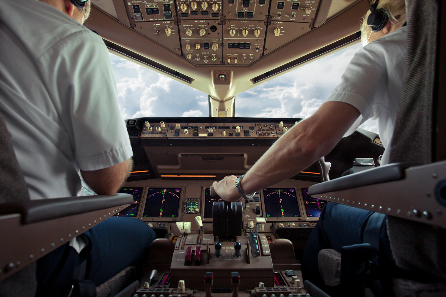 Two airline pilots in a cockpit flying into clouds