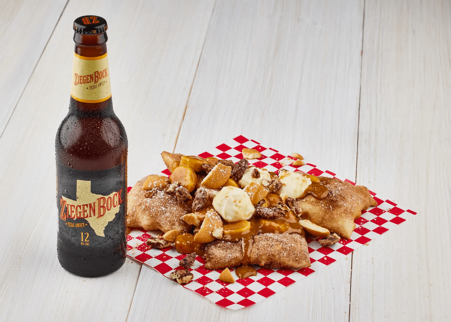 Bourbon banana caramel sopapillas next to a beer bottle