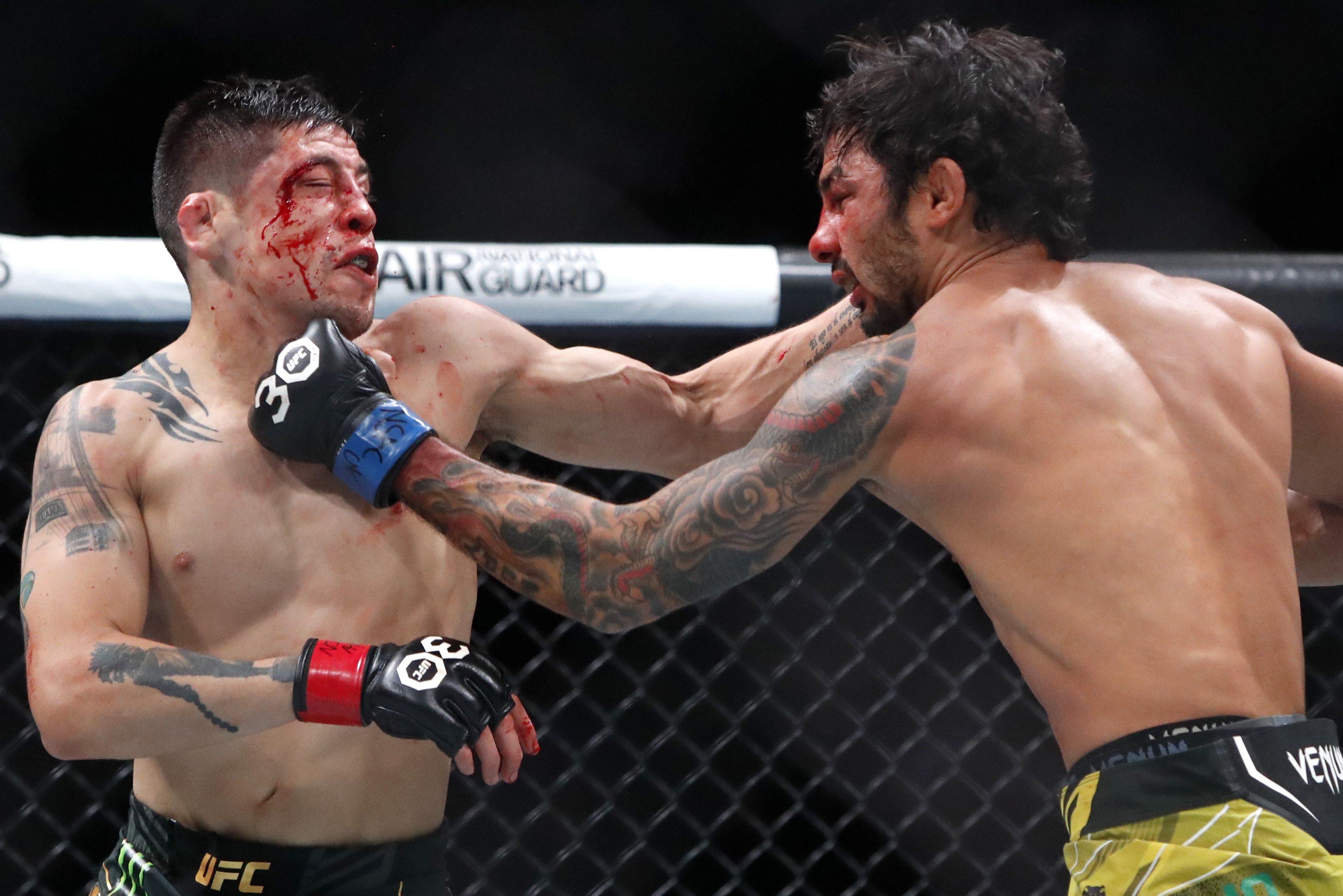 Alexandre Pantoja punches Brandon Moreno during their championship fight.