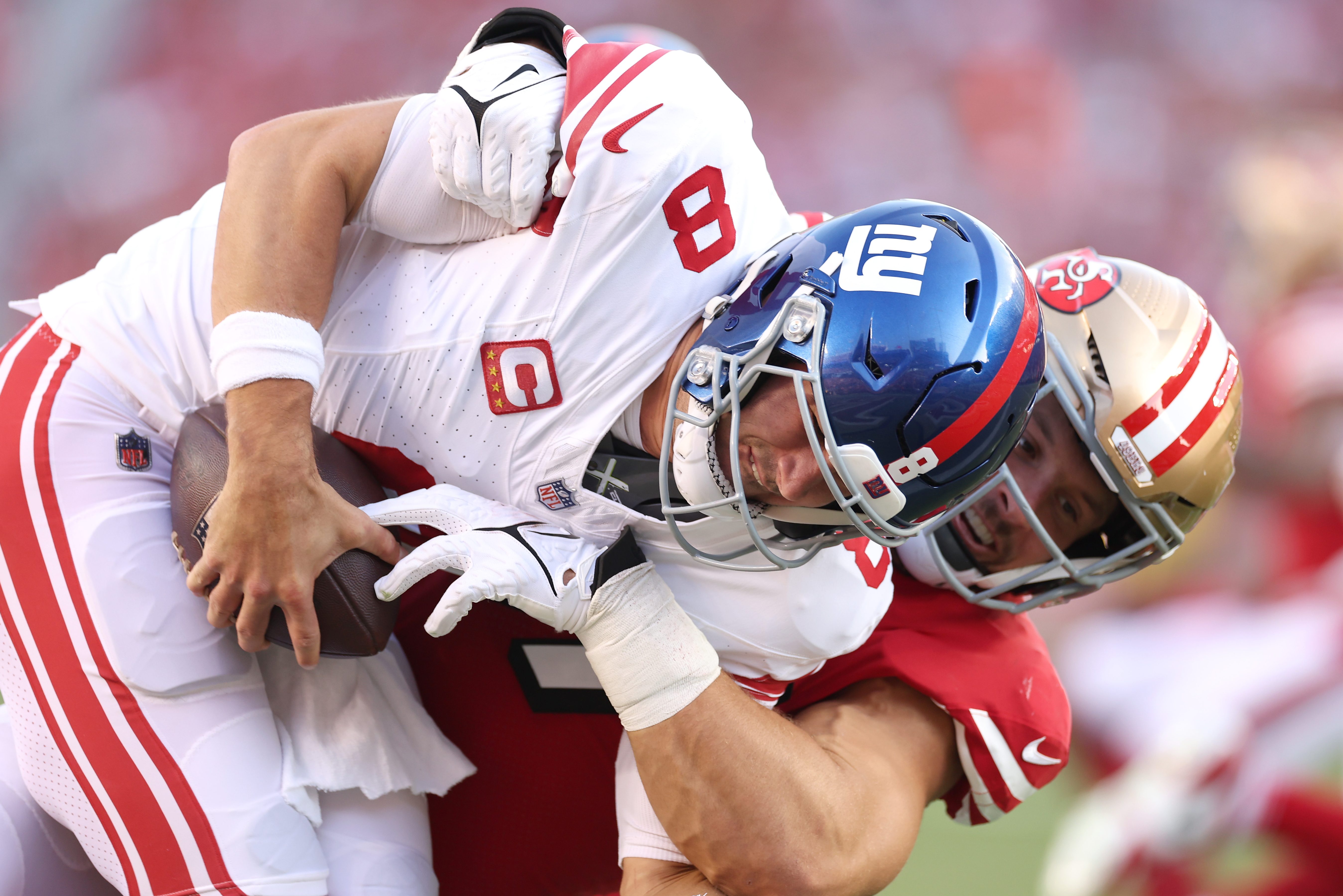 Daniel Jones take a hit against San Francisco.