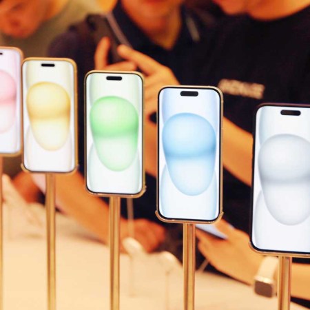Customers experience the newly launched iPhone 15 series at Apple's flagship store in Shanghai, China, September 24, 2023