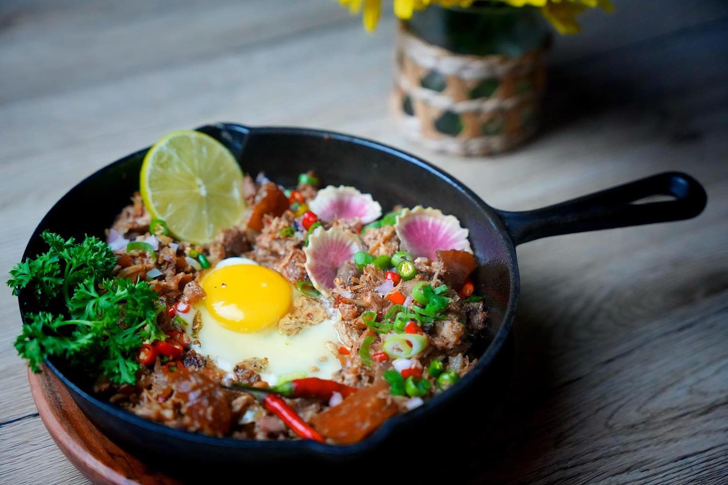 lechon sisg kamayan atl in a cast iron pan