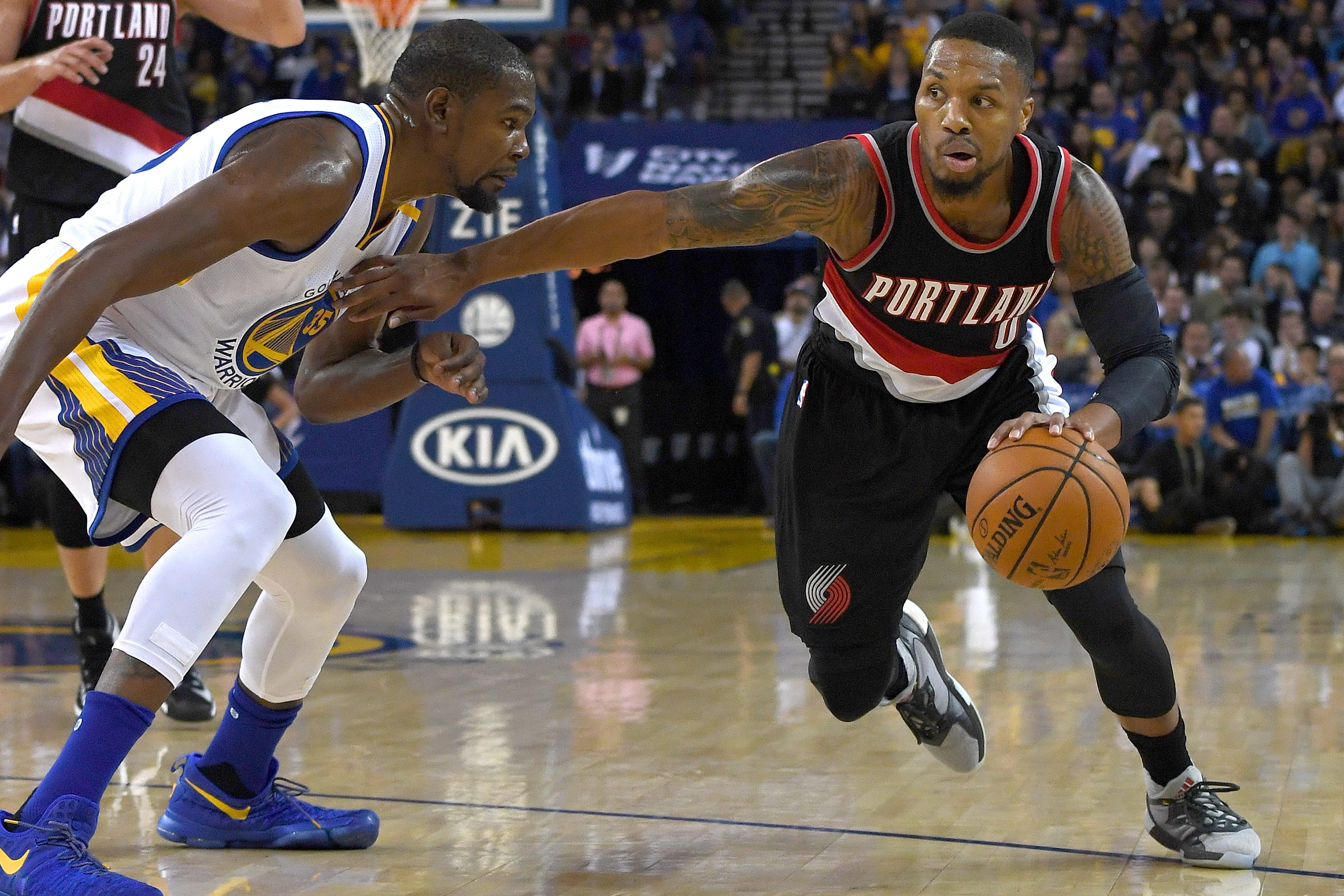 Damian Lillard drives the ball against Kevin Durant.
