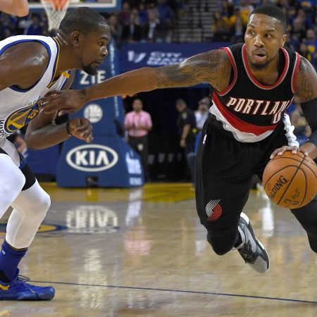 Damian Lillard drives the ball against Kevin Durant.