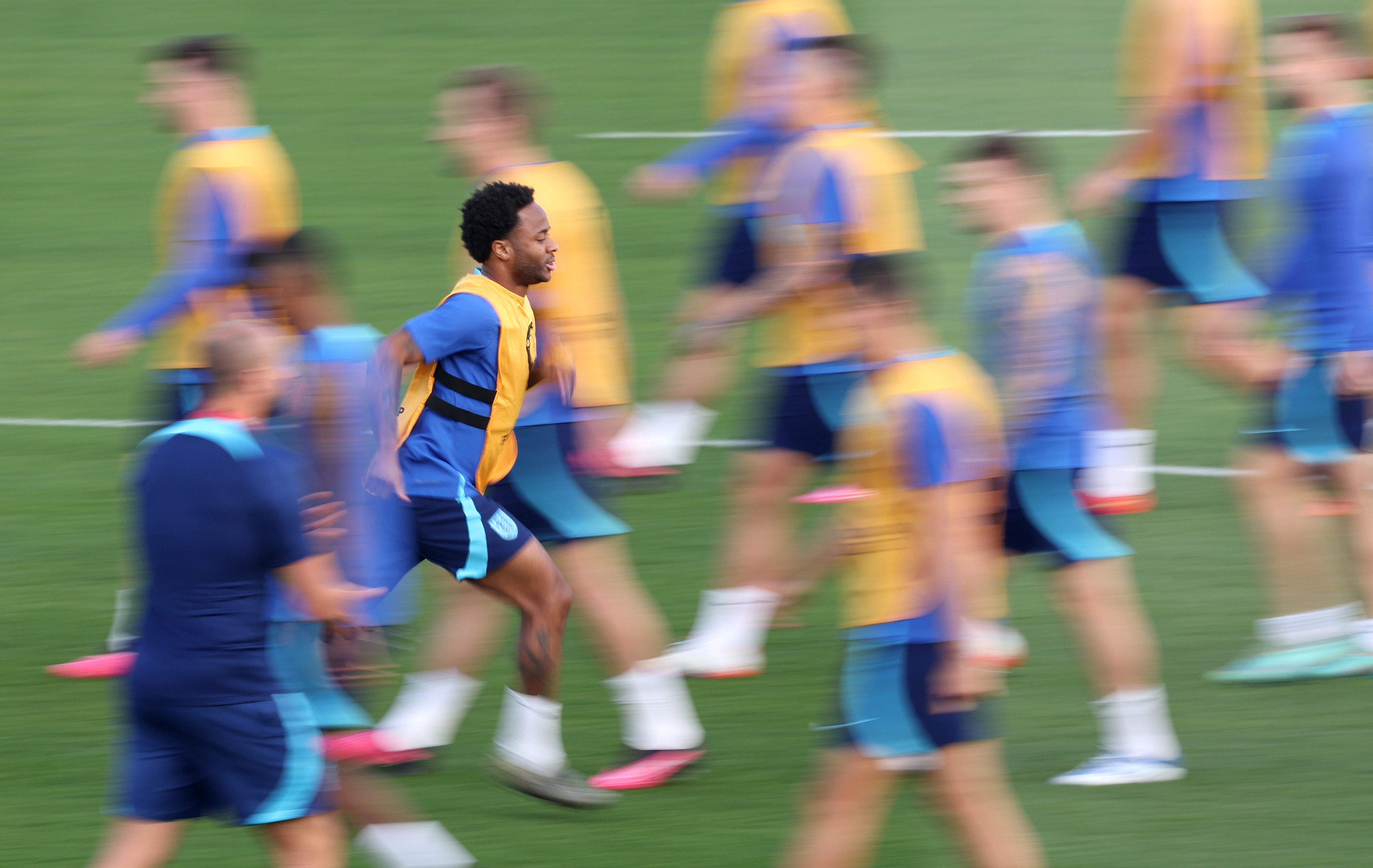 Raheem Sterling skipping on the field in training.