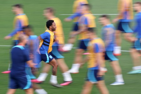 Raheem Sterling skipping on the field in training.