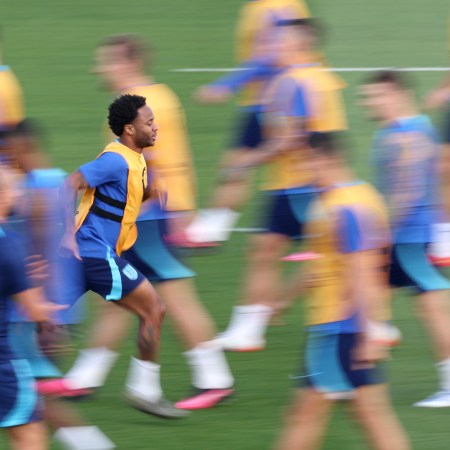 Raheem Sterling skipping on the field in training.