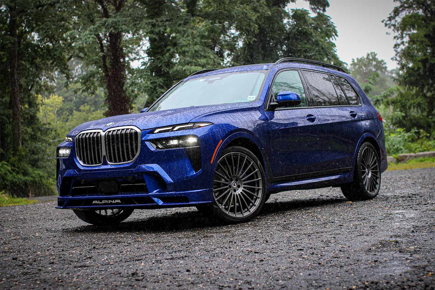 2023 BMW Alpina XB7 SUV in blue sitting in the rain