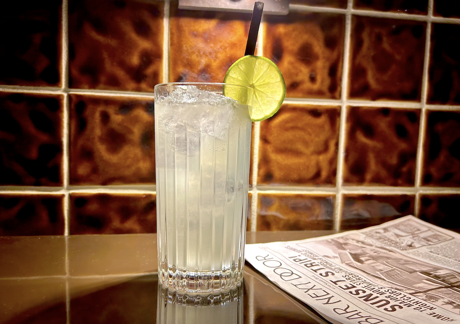 Moscow mule in a glass with a lime next to a newspaper