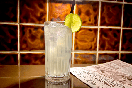 Moscow mule in a glass with a lime next to a newspaper