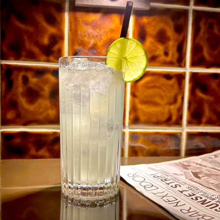 Moscow mule in a glass with a lime next to a newspaper