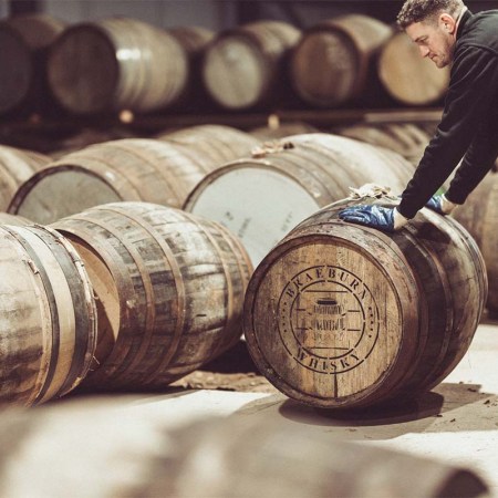 Barrels in a warehouse labeled Braeburn. The company allows investors to put their money into whisky casks.