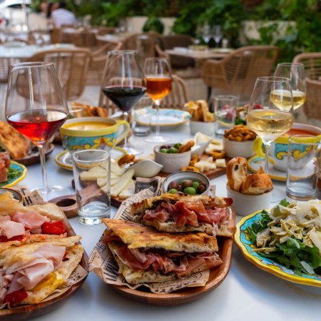 Spread of wine and sandwiches on a table from Sogno Toscano in Santa Monica
