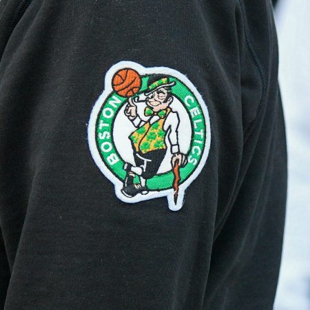 The Celtics logo on a fan's sweatshirt.