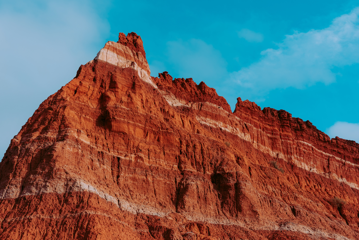 Layers of sedentary rock on the walls of the Palo Duro Canyon State Park in Canyon, Texas. The white lines in the walls of the canyon are formed from minerals of ancient lake beds that evaporated