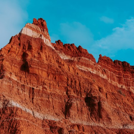 Layers of sedentary rock on the walls of the Palo Duro Canyon State Park in Canyon, Texas. The white lines in the walls of the canyon are formed from minerals of ancient lake beds that evaporated