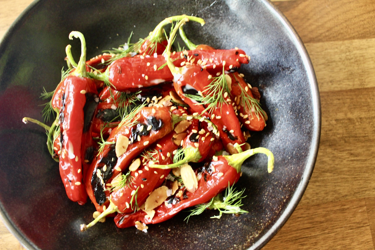 Charred shishito peppers with garlic aioli, sesame, cumin and almonds