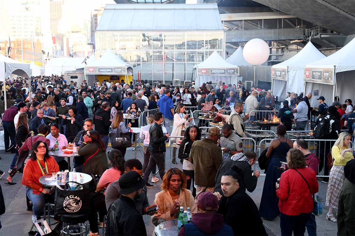 Guests attend the Food Network New York City Wine & Food Festival presented by Capital One - Backyard BBQ presented by Pat LaFrieda Meats hosted by Dario Cecchini and Andrew Zimmern on on October 16, 2022 in New York City