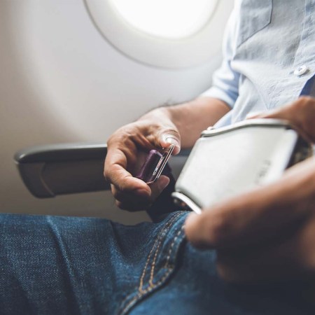 A person fastening a seatbelt on an airline. Some airlines claim Ozempic could lead to weight loss and save airlines millions.