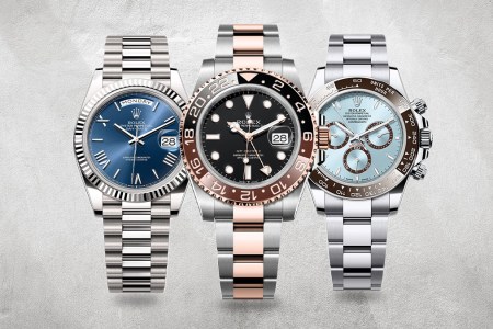 Three silver watches with blue and pink accents