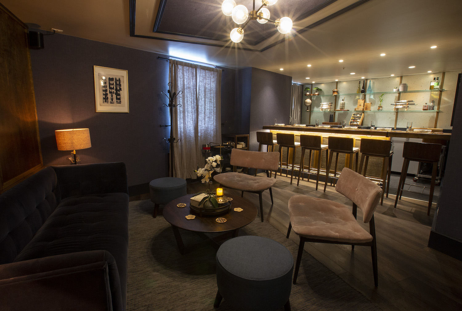 Small lounge/bar area with a couch and dim lighting