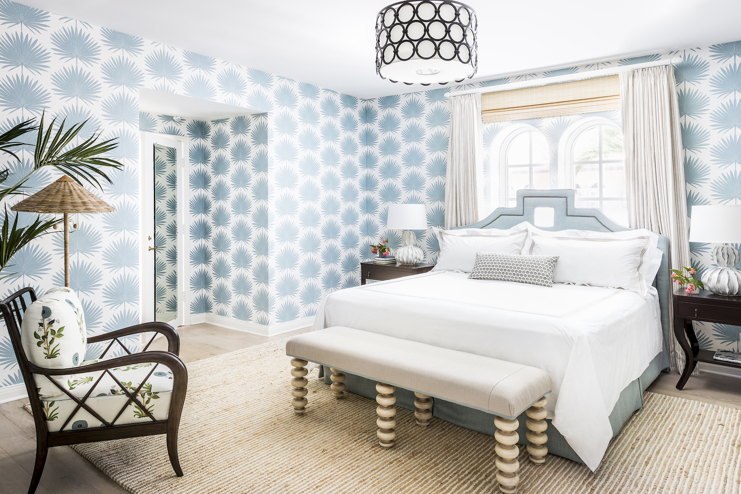 Blue and white room with bed and other furniture