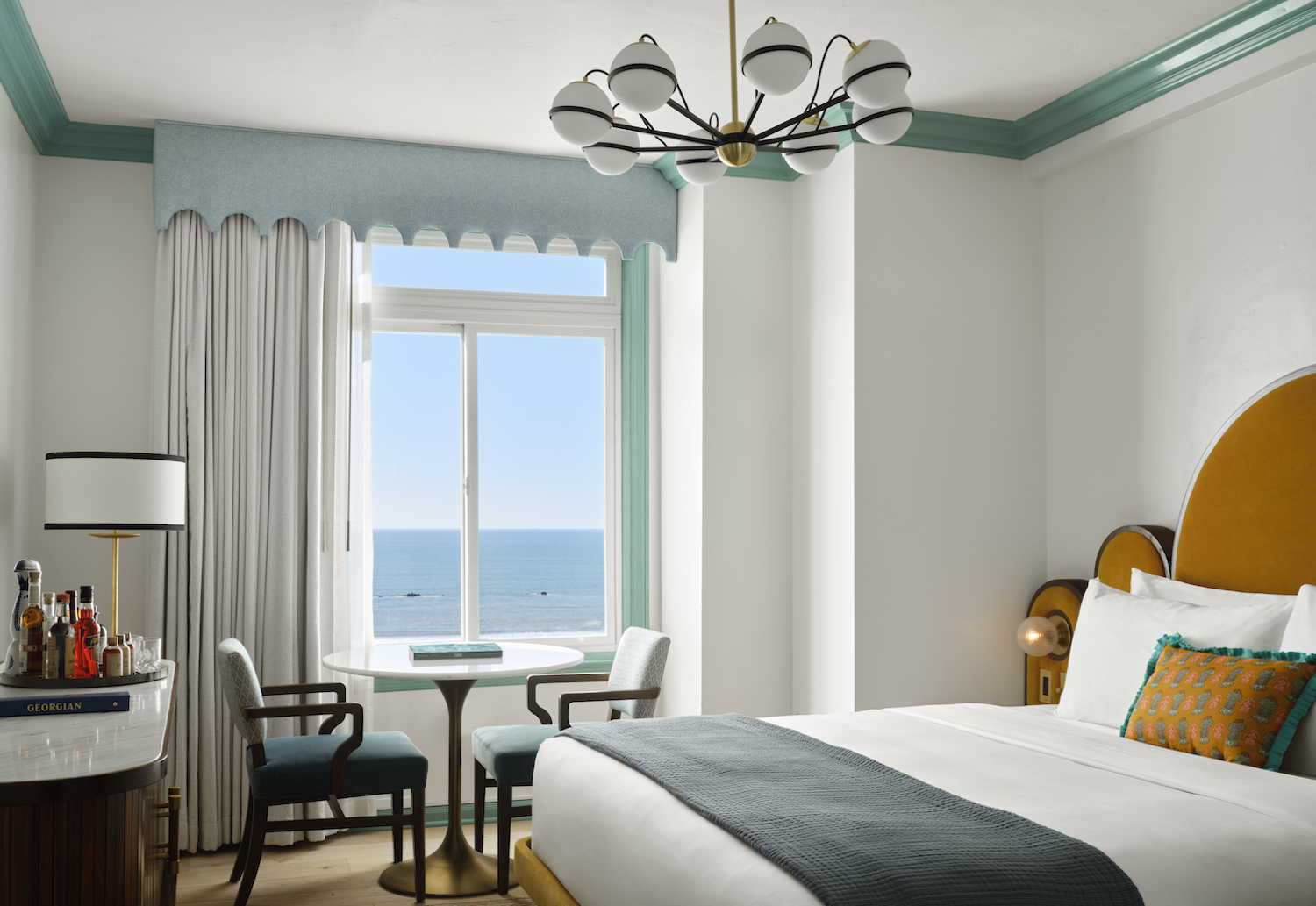 The Georgian room with white and blue accents and an ocean view