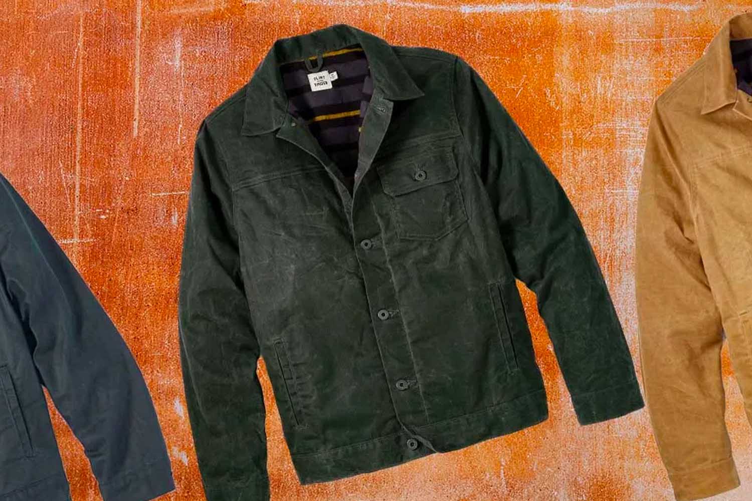 Three waxed trucker jackets on an orange background