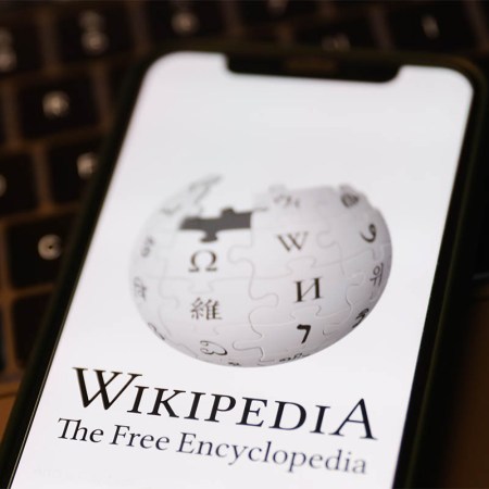 Wikipedia logo displayed on a phone screen and a laptop keyboard are seen in this illustration photo taken in Krakow, Poland on January 19, 2023. Elon Musk has questioned the need for donations to the site.