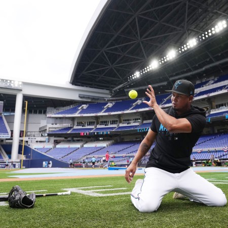 The baseball player Luis Arraez warms up before a game.