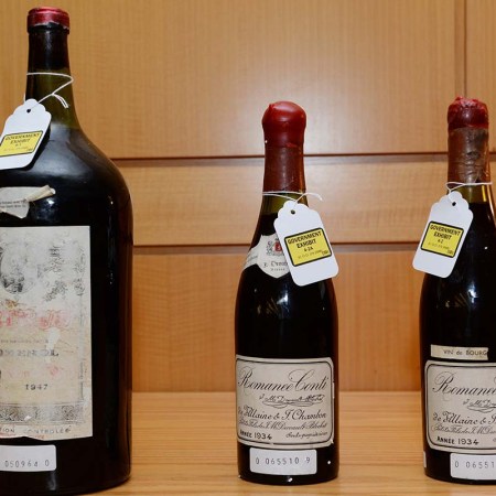 Three bottles of wine used as evidence in the trial of wine dealer Rudy Kurniawan are displayed in Federal Court on December 19, 2013 in New York. Kurniawan was found guilty of masterminding a lucrative scheme to sell fake vintage wine in New York and London. He's now out and hosting dinner parties serving his fake wine.