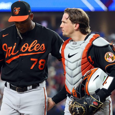 Baltimore Orioles players walk back to the dugout.