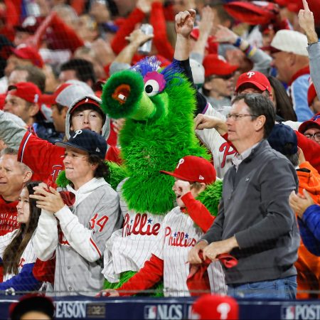 The Phanatic cheers with Phillies fans in the stands.
