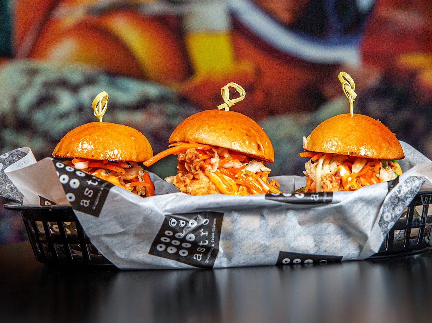 Asteroid Chicken Sliders, with fried chicken, lettuce, pickles and japaleño coleslaw on mini brioche buns