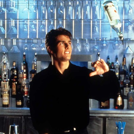Tom Cruise showing his tricks as a bartender in a scene from the film 'Cocktail', 1988.