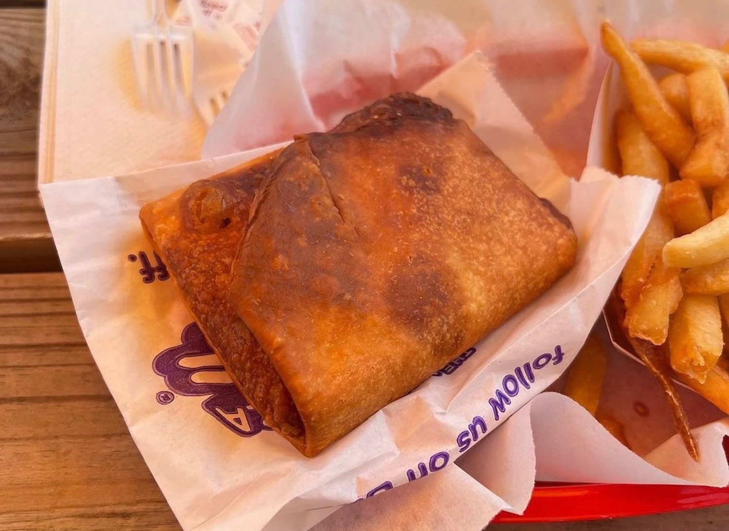Stuffed pizza puff pastry in a bakset with fries