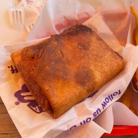 Stuffed pizza puff pastry in a bakset with fries
