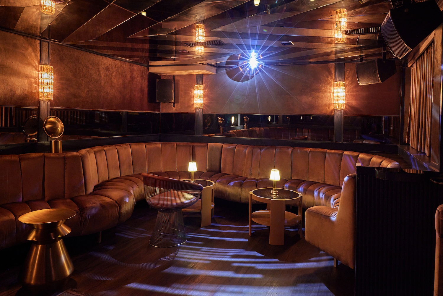Lounge area with booth seats and a disco ball 