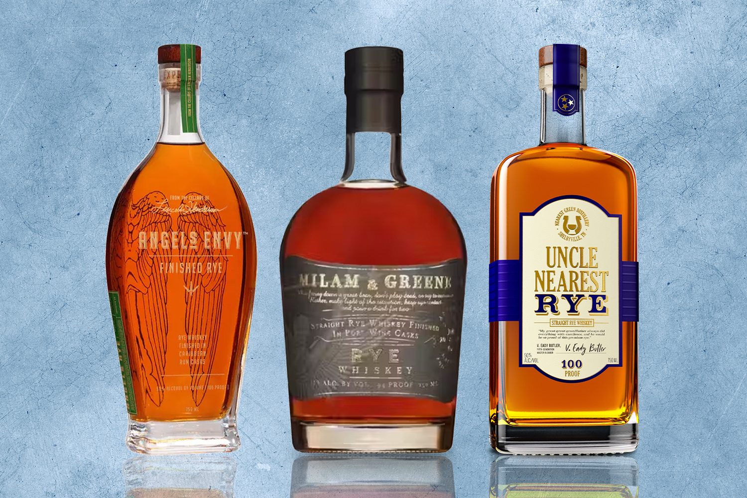 lineup of three bottles of rye whiskey on a blue textured background