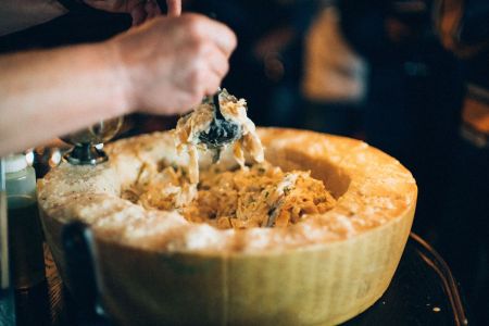 Man twirling pasta in large bowl