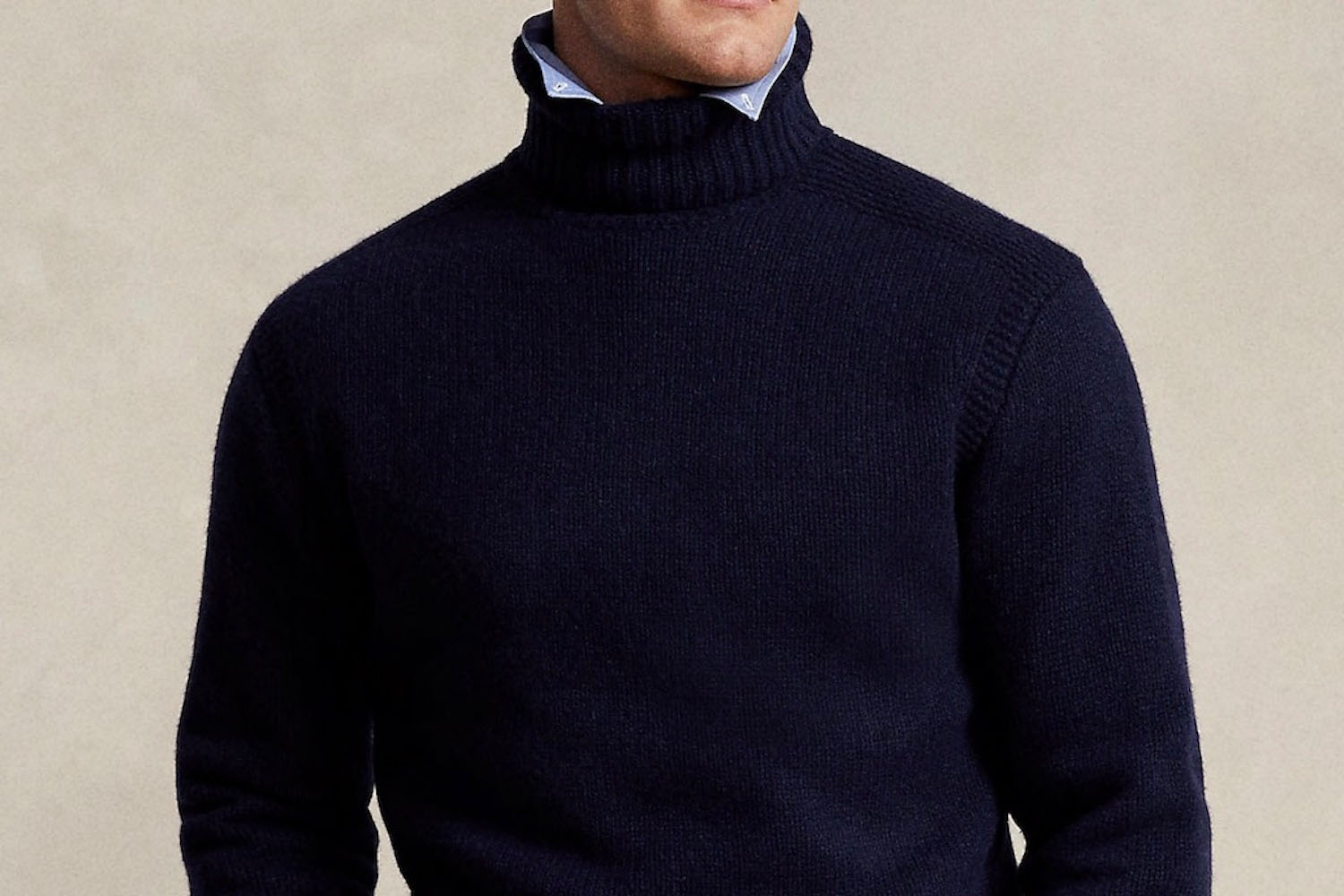 a model wearing a black turtleneck over a blue oxford