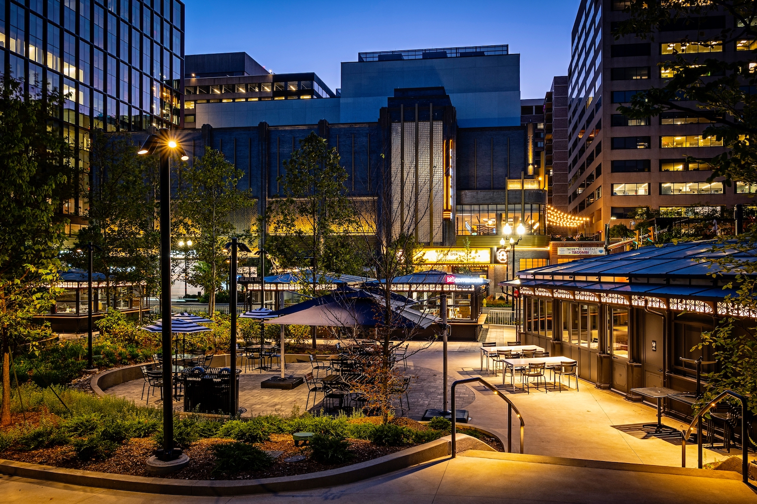 Exterior of Water Park, overlooking plot of land with tables, bars and lights