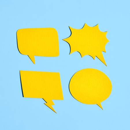 Four yellow comic book voice bubbles against a light blue background.