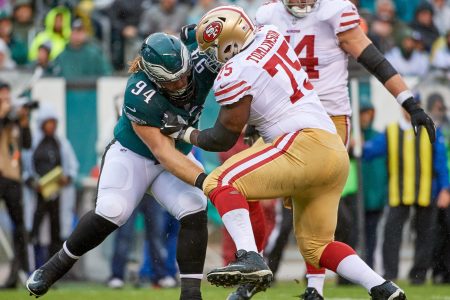 Eagles and 49ers linemen battle during an NFL football game.