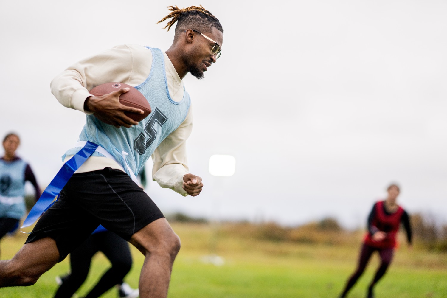 A group of people playing flag football, a sport that the NFL is investing in internationally with a new youth tournament program in France