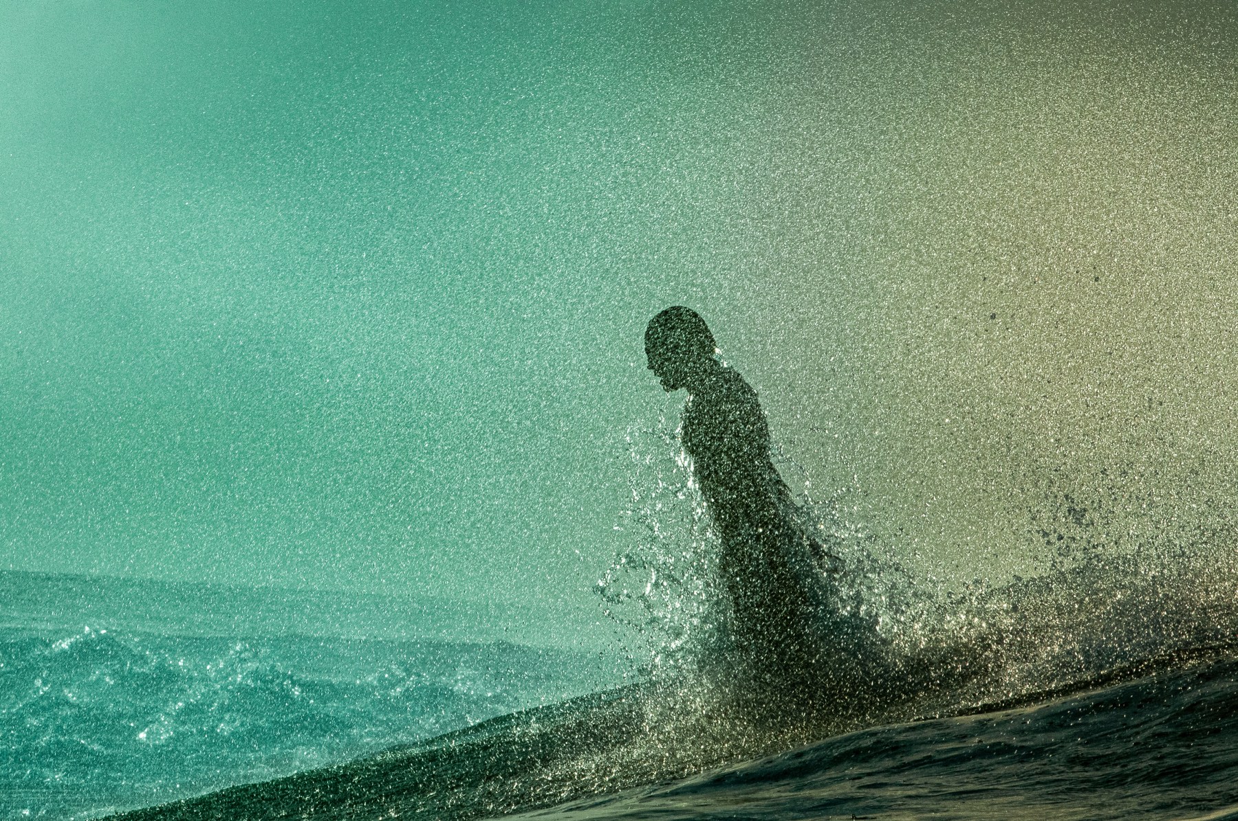 This is somebody torpedoing out of the back of a wave in Tahiti. I photographed this as a part of a film for Patagonia that was called <em>Plight of The Torpedo People</em>. It was about bodysurfing. One of the things you can do when you bodysurf is ride the current of a breaking wave in reverse and let it suck you up and shoot you out the back like a dolphin. This person is dolphin-ing here. I wasn't really aiming for this, but it just happened and came to life. It was a wild moment.